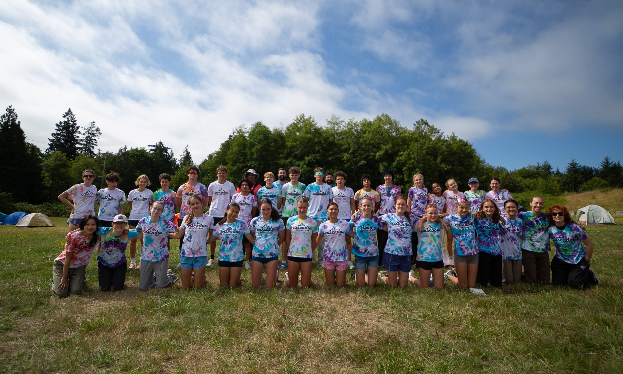 Cascadia Running Camp 2026 in Port Gamble group photo in tie-dye t-shirts
